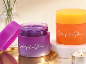Colorful ushine purple glitter body scrub jar and orange cosmetic container on elegant vanity setup
