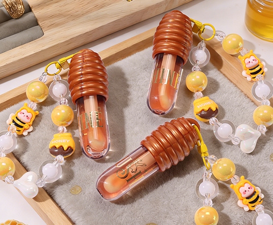 Honey-shaped lip gloss tubes with cute bee beaded keychain charms